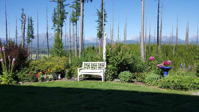 Private deck with mountain views at Faithful Keep retreat near Glacier NP